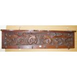 A VINTAGE MAHOGANY COAT RACK & SHELF with carved panel of mythical beasts and central 'W A'