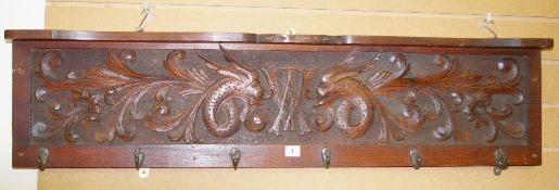 A VINTAGE MAHOGANY COAT RACK & SHELF with carved panel of mythical beasts and central 'W A'