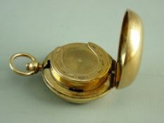 A NINE CARAT GOLD PLAIN CASED SOVEREIGN HOLDER, the inside coin grip in the form of a horseshoe,