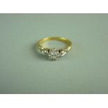 A LADY'S EIGHTEEN CARAT GOLD & PLATINUM SOLITAIRE DIAMOND RING with flanking marcasites, visual