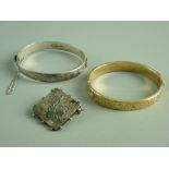A NINE CARAT GOLD (with metal core) HALF BRIGHT CUT OVAL BANGLE, 14 grms, a similar sterling