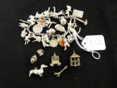 Small parcel of white metal charms and a charm bracelet