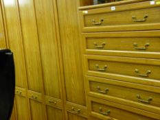 Excellent suite of wood effect modern bedroom furniture comprising three wardrobes, chest of five