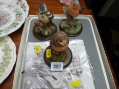 Three country artists garden birds on plinths figures & a quantity of place mats
