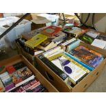 A large quantity in several boxes of paperbacks & other reading material