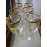 A set of six wine glasses with gilt trim