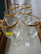 A set of six wine glasses with gilt trim