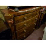 A Victorian bow fronted chest of two short over three long drawers with turned wooden knobs inset