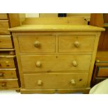 A vintage stripped pine chest of two short over two long drawers