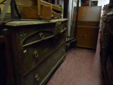 An oak chest of four drawers, a single door china display cabinet & a small bureau
