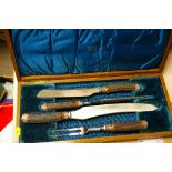 A wooden boxed four-piece carving set by The Murfin Brothers of Sheffield