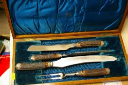 A wooden boxed four-piece carving set by The Murfin Brothers of Sheffield