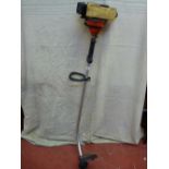 A petrol grass trimmer