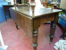 A Victorian mahogany table with single drop leaf on turned segmented & blocked supports with brass
