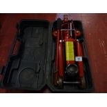 A plastic cased small trolley jack