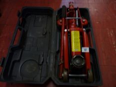 A plastic cased small trolley jack