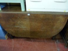 An antique mahogany drop leaf dining table