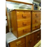 A teak mirror back dressing chest & a pair of matching three-drawer bedside cabinets