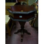 A reproduction mahogany pedestal work table, the lift up lid with interior lidded sections