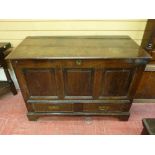 A LATE 18th/EARLY 19th CENTURY OAK DOWER CHEST having a triple fielded panel front with two base