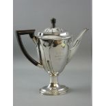 A SILVER OVAL BASED COFFEE POT with tapered and patterned body, with Arts & Crafts style decoration,