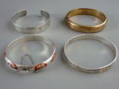FOUR SILVER BANGLE BRACELETS including a gilt half chased decorated example, stamped Birmingham