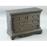 A WELSH SLATE FOLK ART piece in the form of a chest of drawers having blind drawer frontage with