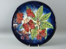 A FINE LARGE BLUE GROUND MOORCROFT 'SIMEON' CHARGER by Gibson, 36 cms diameter