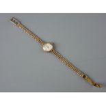 A LADY'S NINE CARAT GOLD CIRCULAR DIAL LONGINES WRISTWATCH with four bar nine carat gold bracelet,