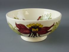 A MOORCROFT 'COLOMBINE' 16 cms DEEP DISH BOWL, decorated on a cream ground, impressed Moorcroft to