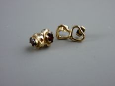 A PAIR OF NINE CARAT GOLD OVAL GARNET EARRINGS and a pair of yellow metal heart shaped earrings