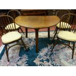 A QUALITY REPRODUCTION OAK CRICKET TYPE DINING TABLE and four hoop spindlebacked dining chairs