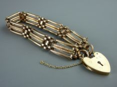 A NINE CARAT GOLD FOUR BAR BRACELET with safety chain and padlock, 15 grms