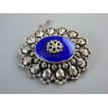 AN OVAL SILVER BROOCH, London 1954 with a central oval blue enamel tablet with centre cz