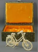 A CHINESE MINIATURE CARVED IVORY BICYCLE, fully reticulated and detailed with folding support stand,