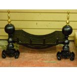 A CAST IRON FIRE BASKET on a pair of brass top dog irons, 61 cms wide