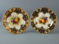 A PAIR OF ROYAL WORCESTER FRUIT DECORATED CABINET PLATES, signed A Shuck, having shaped edges,