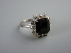 AN EIGHTEEN CARAT WHITE GOLD DRESS RING with dark amethyst square cut centre stone and twelve