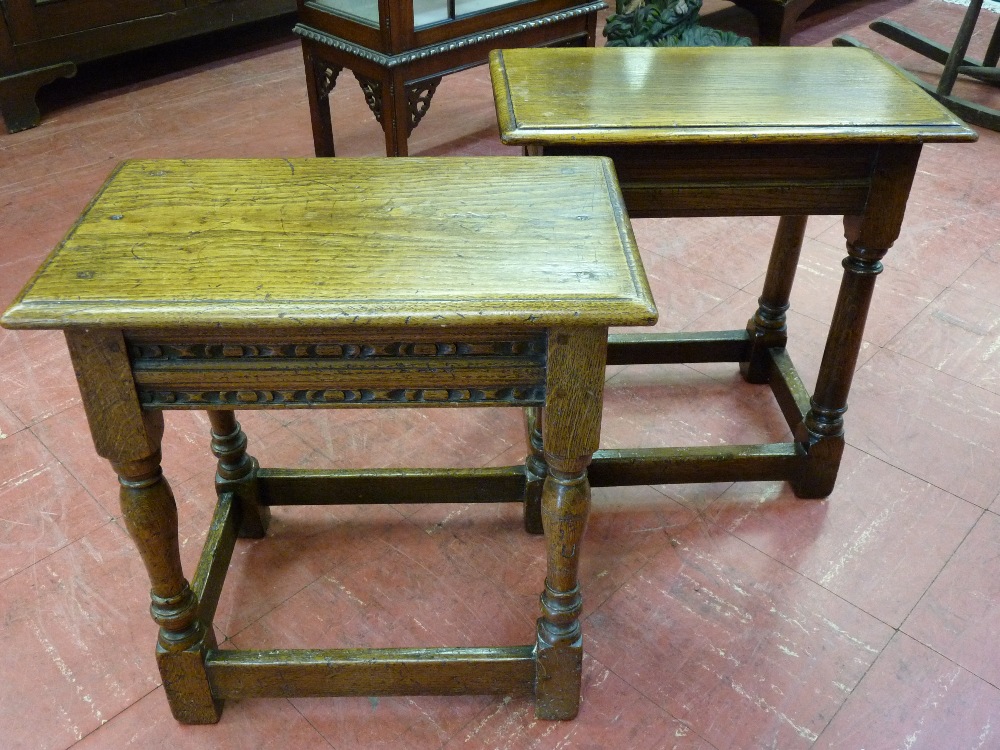 TWO OAK OBLONG TOPPED RUSTIC COFFEE TABLES with turned and block supports and oblong stretchers