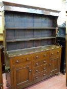 A 19th CENTURY WELSH OAK DRESSER, the shaped sided two shelf rack with wide backboards over a