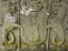 A CONSTITUTED STONE COAT OF ARMS featuring a central shield with castellated tower and mask figure