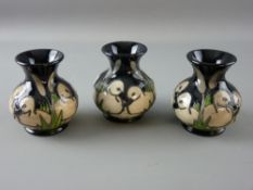 A SET OF THREE MOORCROFT SHORT NARROW NECKED VASES by Vicky Lovatt, dated 2012, each depicting three