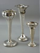 THREE CIRCULAR BASED SILVER ROSE VASES with tapered stems (condition variable)