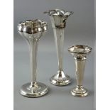 THREE CIRCULAR BASED SILVER ROSE VASES with tapered stems (condition variable)