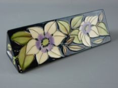 A MOORCROFT 'SOPHIE CHRISTINA' TRIANGULAR ADVERTISING PLAQUE, decorated on a blue/green