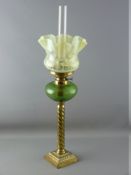 A VICTORIAN OIL LAMP with brass twist column, green glass reservoir and vaseline glass shade