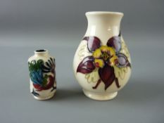 A MOORCROFT 'COLOMBINE' VASE and a Nicola Slaney miniature with comical peacock design, both