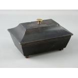 A WELSH SLATE FOLK ART piece in the form of a sarcophagus shaped lidded casket, the lid with brass
