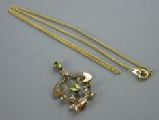 A NINE CARAT GOLD SCROLLED PENDANT with peridot and seed pearls, 1.5 grms and a yellow metal five