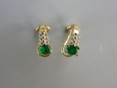 A PAIR OF FOURTEEN CARAT GOLD DIAMOND & EMERALD EARRINGS each having an oval emerald approximately 4